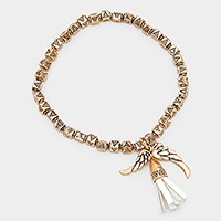 Faux suede tassel & wing charm aztec metal bead stretch bracelet